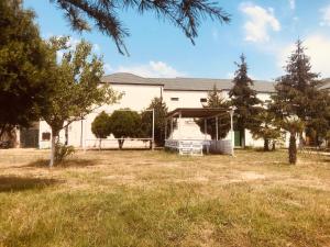 a white building with ashed in a yard at Wild Caspian coast in Aşağıoba