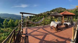 a patio with a table and a gazebo at Quinta da Eira do Prado in Carvalho