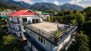 an aerial view of a house with a red roof at Mona's Villa Homestay in Dharmsāla