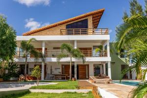 a house with a pool in front of it at GreenHousi Boutique Preá in Prea