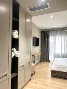 a hotel room with a bed and a desk at Hotel EIBA in Peshkopi