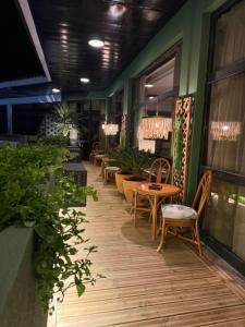 a restaurant with chairs and tables and plants on a hallway at Hotel Lusitano in Vilar Formoso