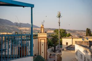 a building with a clock tower on top of a city at Riad Lik in Fez