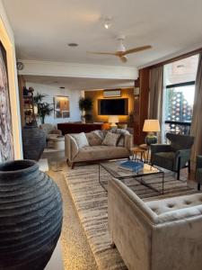 a living room with two couches and a table at Hotel Lusitano in Vilar Formoso