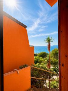 an orange building with a view of the ocean at West Sardinia - Bosa in Magomadas