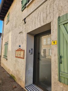 a door to a building with a sign on it at Studio tout confort in Le Fossat +2 photos