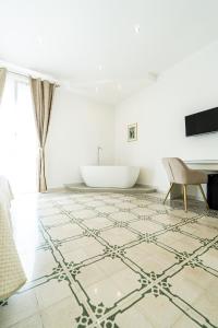 a living room with a tub and a rug on the floor at Palazzo Sorge - Sicilian Charm in Balestrate