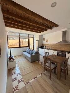 a living room with a couch and a table at Apartamentos_Lovely_Rooms_Vic in Vic