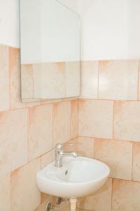 a bathroom with a sink and a mirror at Noa Hotel Velipoje in Velipojë