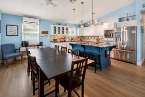 a large kitchen with a table and chairs in it at Spacious & Pet Friendly - Game Room Sleeps 10 in Port Aransas