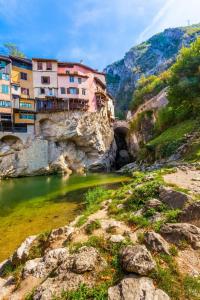 a group of buildings on a hill next to a river at Les Terrasses du Vercors in Beauregard-Baret