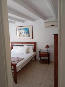 a bedroom with a bed and a side table at Avraam Apartment Polychrono in Polychrono