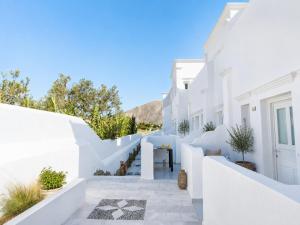 a staircase in a white house with white walls at Perissa Design Centro Suites- BEACH FRONT in Perissa