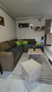a living room with a couch and a table at Napsugár Nyaraló in Tiszaalpár