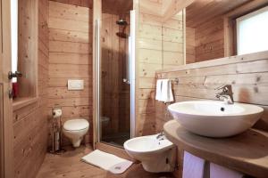 a bathroom with a white sink and a toilet at Au Rascard in Brusson +14 photos