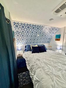 a bedroom with a large bed with a blue wall at Hidden Anchor in Burton