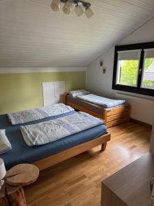 a bedroom with two beds and a window at Ferienwohnung Miesseler in Kall