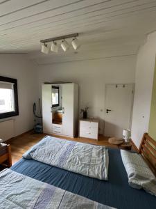 a bedroom with a large bed and a mirror at Ferienwohnung Miesseler in Kall