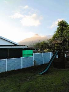 a playground slide in a yard with a fence at Garden Route Retreat in George