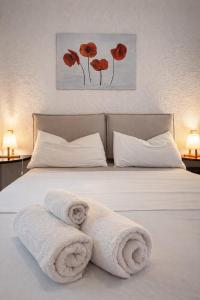 a bedroom with a bed with towels on it at West Sardinia - Bosa in Magomadas +41 photos