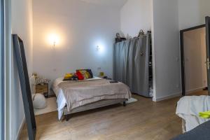 a bedroom with a bed and a mirror in it at villa avec piscine in Hendaye +5 photos