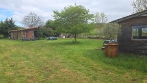 a yard next to a house with a building at Les Dômes du Ceyssoux in Le Brignon