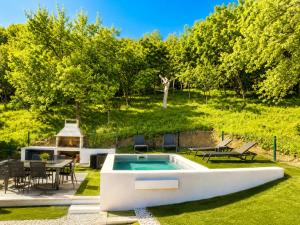 a backyard with a swimming pool and a table and chairs at House Veles in Vrbovsko