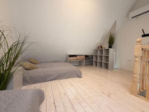 a bedroom with a bed and a wooden floor at Sunset House Svencele in Svencelė