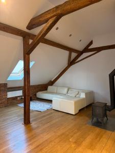 a bedroom with a bed in a room with wooden floors at Timber City Loft in Slezská Ostrava