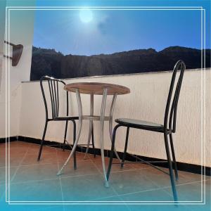 a table and two chairs sitting next to a window at Auberge Bab chellalat in Tamarout