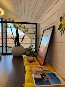 a room with a couch with a laptop on it at Yellow House Natakhtari in Mtskheta