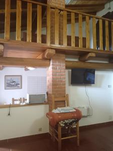 a room with a table and a chair and a staircase at La casetta di Marmora in Marmora