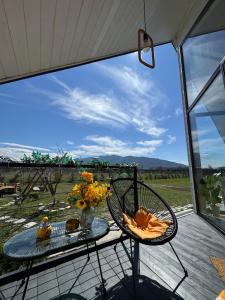 a table and chairs on a patio with a view at Yellow House Natakhtari in Mtskheta