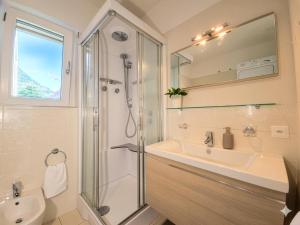 a bathroom with a shower and a sink at Emerald Apartment City Center in Lugano +12 photos