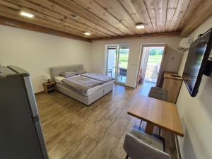 a bedroom with a bed and a table and chairs at Apartma Markelj in Radovljica