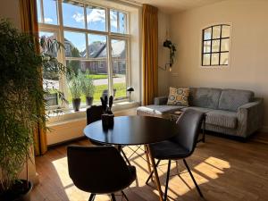 a living room with a couch and a table at Recreatieappartement BoerdeRijlst - De Winkel in Sint Nicolaasga +13 photos