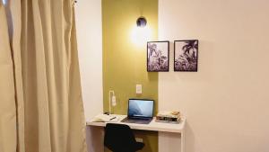 a room with a desk with a laptop computer on it at La Felita, Tu refugio perfecto en Mendoza in Chacras de Coria +17 photos