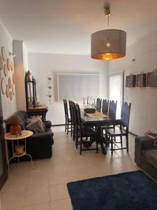 a living room with a dining room table and chairs at Casa dos Avós in Geres