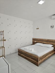 a bedroom with a large bed in a room at Troi beach house in Vlorë