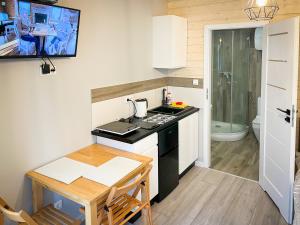 a small kitchen with a stove and a table at Morena in Jarosławiec +133 photos