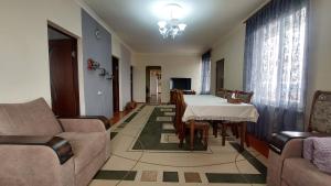 a living room with a table and a couch at Gohar Bed and Breakfast in Tatʼev