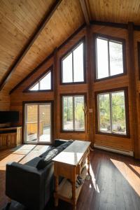 a living room with a couch and a table at Chalets Gallix in Sept-Îles