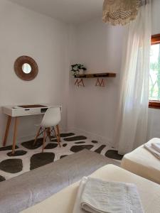 a bedroom with a desk and a table and a chair at Villa Ethel Vourvourou in Vourvourou