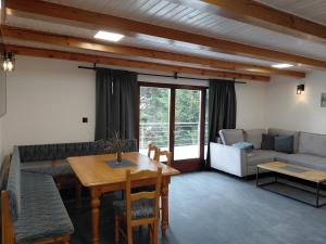 a living room with a table and a couch at Chata Vedle Jedle in Dolní Morava