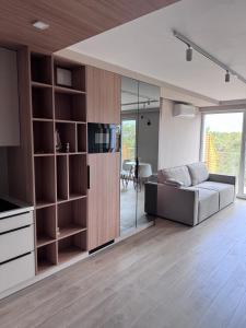 a living room with a couch and a television at Diuna Apartamenty in Rowy +3 photos
