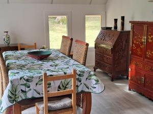 a dining room with a table and a dresser at La Châtelaine in Lombez