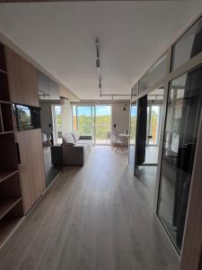 an empty living room with a couch and a table at Diuna Apartamenty in Rowy