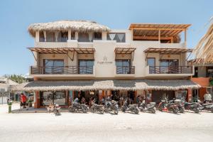 a group of motorcycles parked in front of a building at Punta Arena Surf Suites in Puerto Escondido