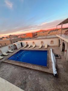 a swimming pool on top of a building at Riad camels house in Merzouga +52 photos