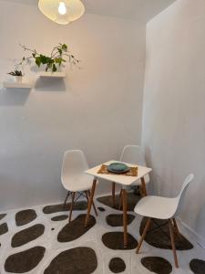 a dining room with a table and four chairs at Villa Ethel Vourvourou in Vourvourou +21 photos